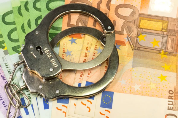 banconote in euro e manette
